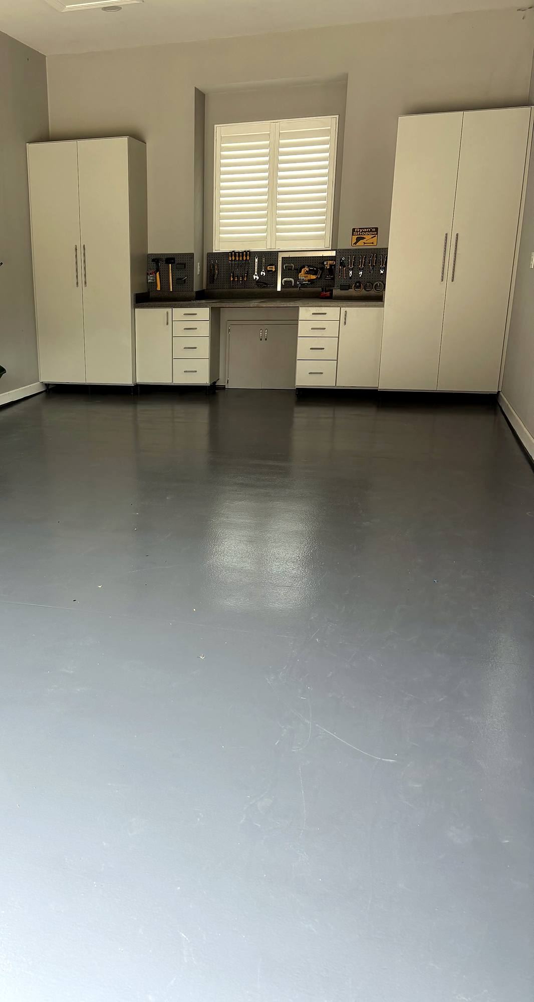 Custom cabinetry over graphite epoxy garage floor